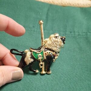 Elegant Gold and Black Lion Brooch with Green Details